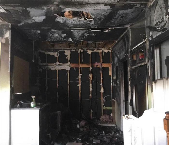 Inside of a home covered in soot and debris due to a fire.